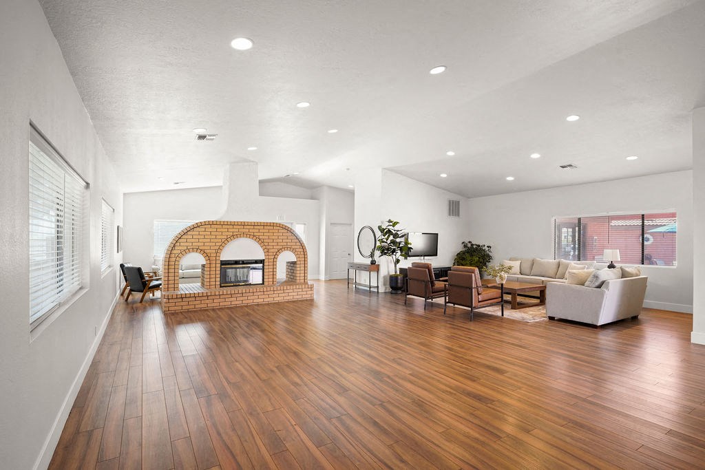 a living room with a fireplace and a wooden floor