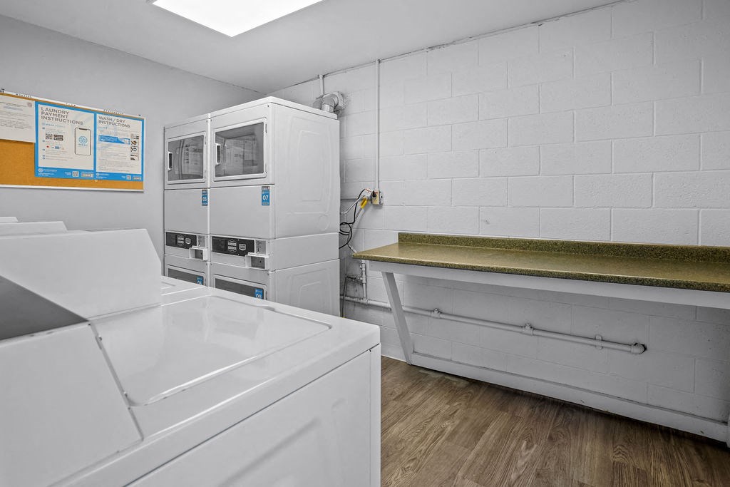 a laundry room with a washer and dryer and a sink