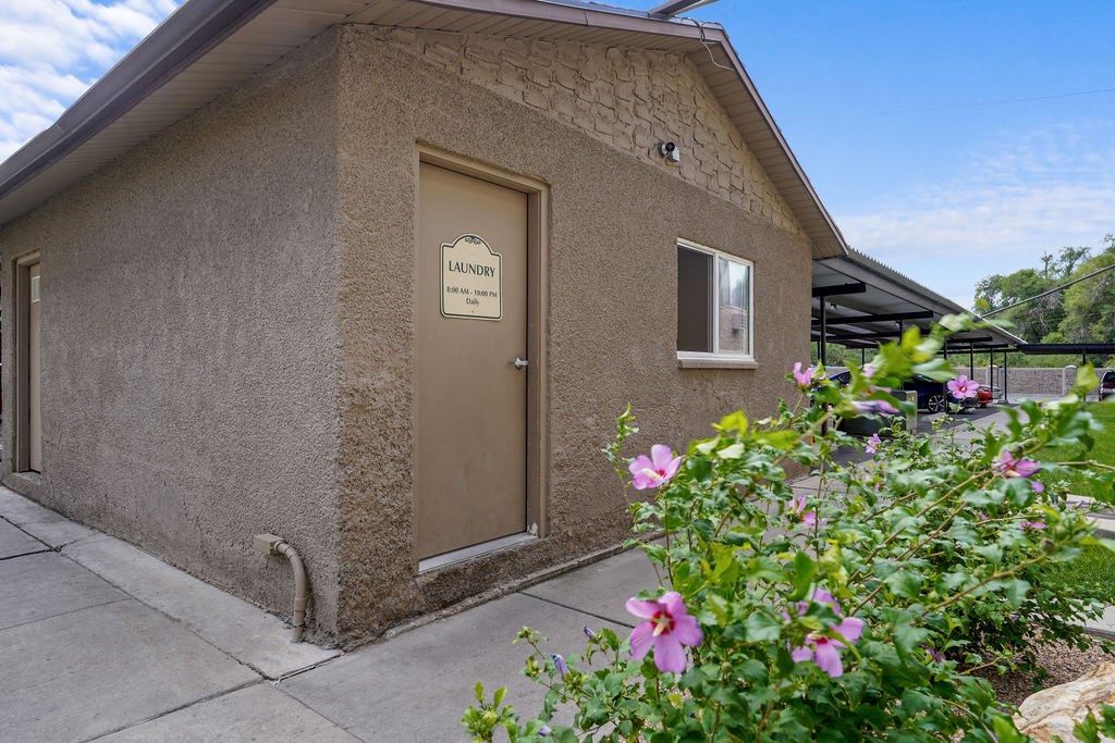 a building with a door and a sidewalk in front of it