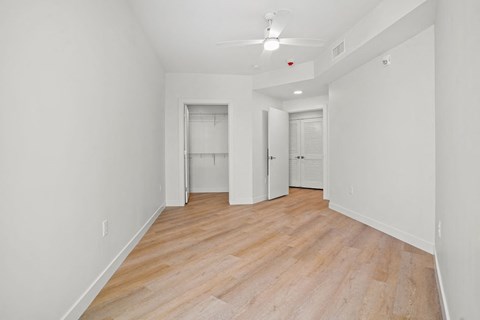 a spacious living room with white walls and wood floors at SPARK Apartments, Salt Lake CIty, 84116