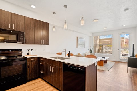 an open kitchen and living room with a table and chairs