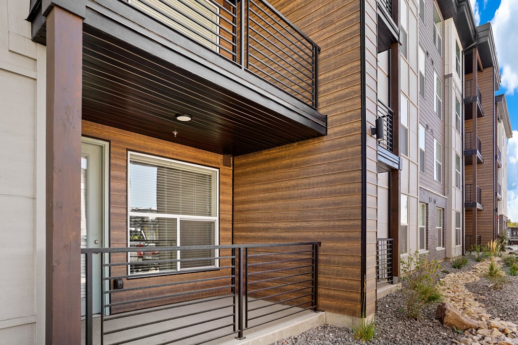 a balcony with a railing in front of a building