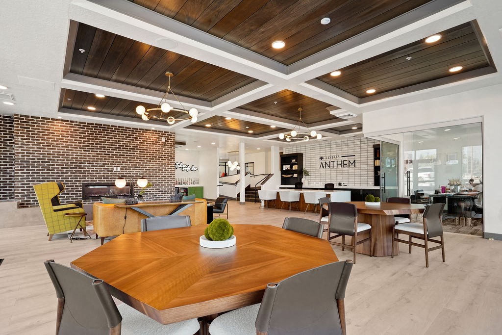 a conference room with a wood ceiling and brick wall