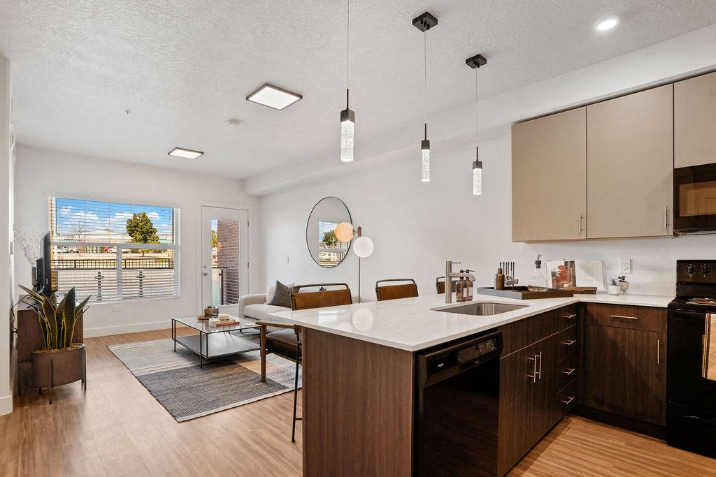 a kitchen with an island and a living room with a couch and a coffee table