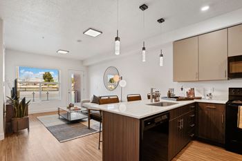 A modern kitchen with wooden cabinets and a large island.