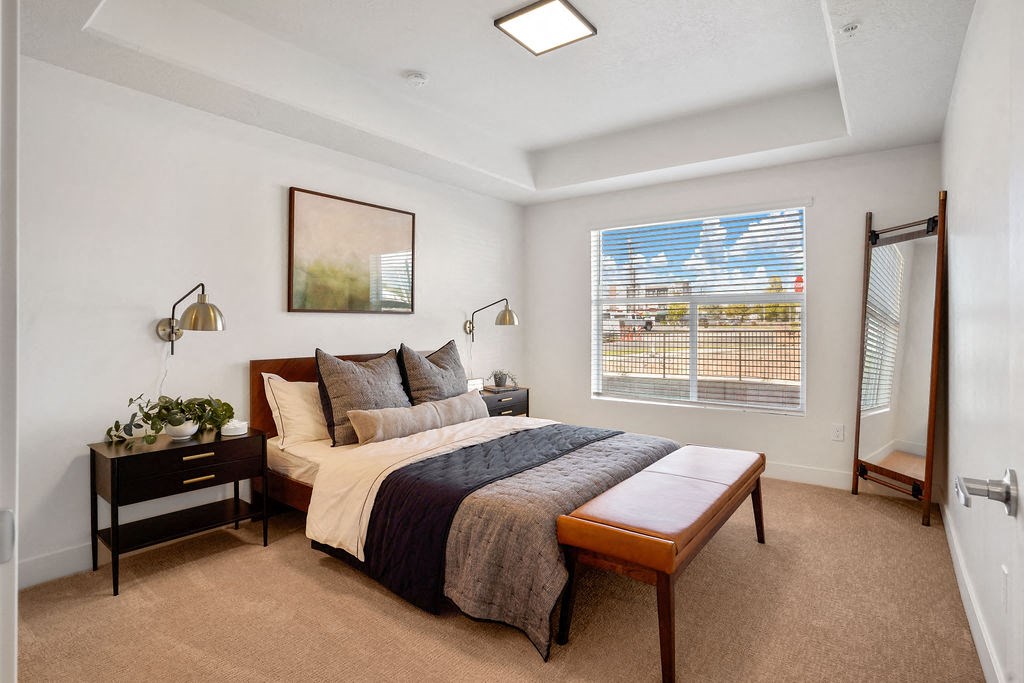 a bedroom with a large bed and a large window