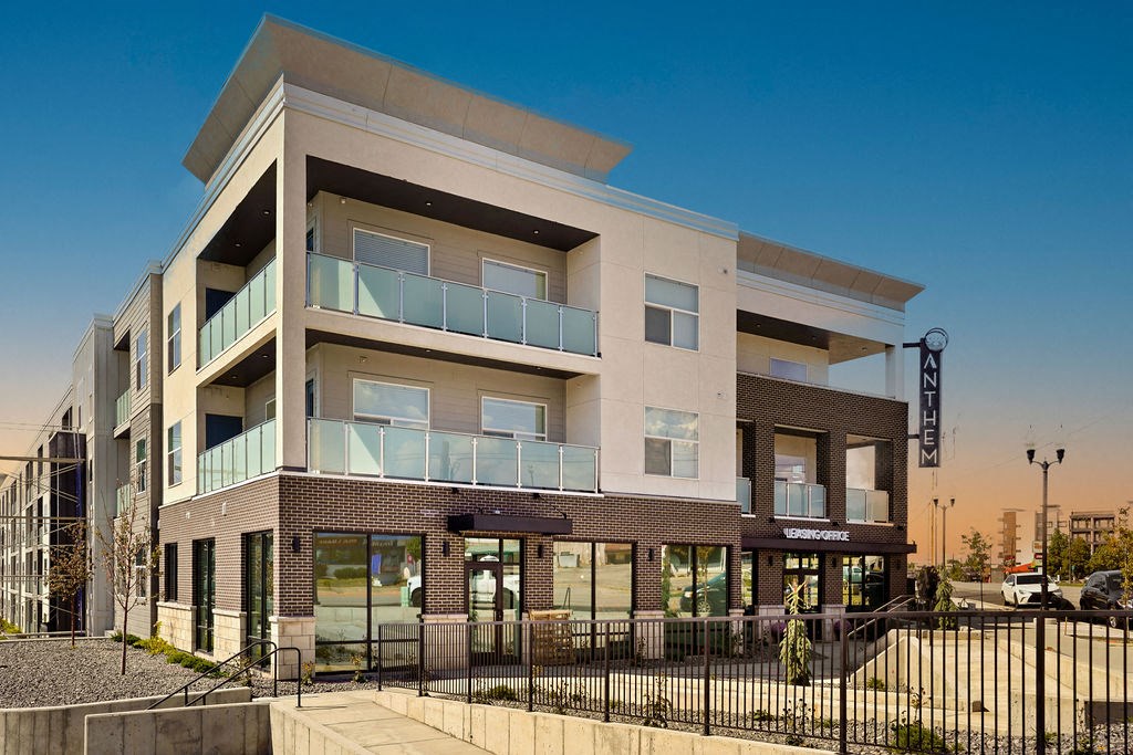 an apartment building with a sign in the background
