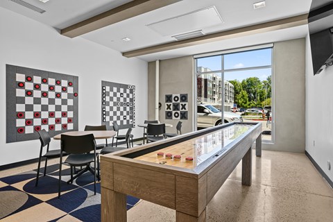 A room with a checkerboard patterned floor and a pool table.