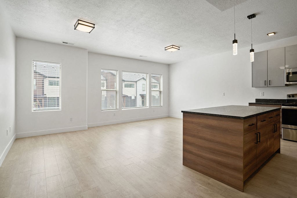 an empty kitchen with a large island in the middle of it