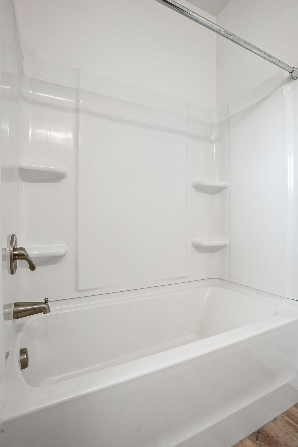 a white bath tub in a bathroom with white walls