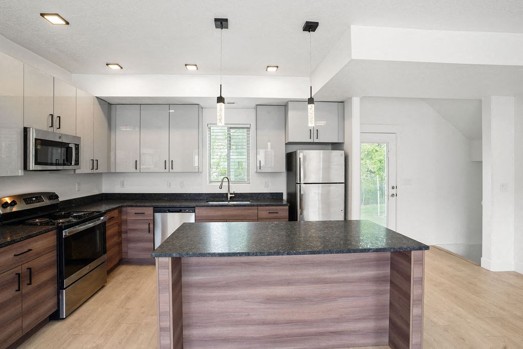 a kitchen with a counter top and a refrigerator