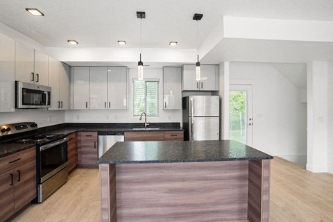 a kitchen with a counter top and a refrigerator