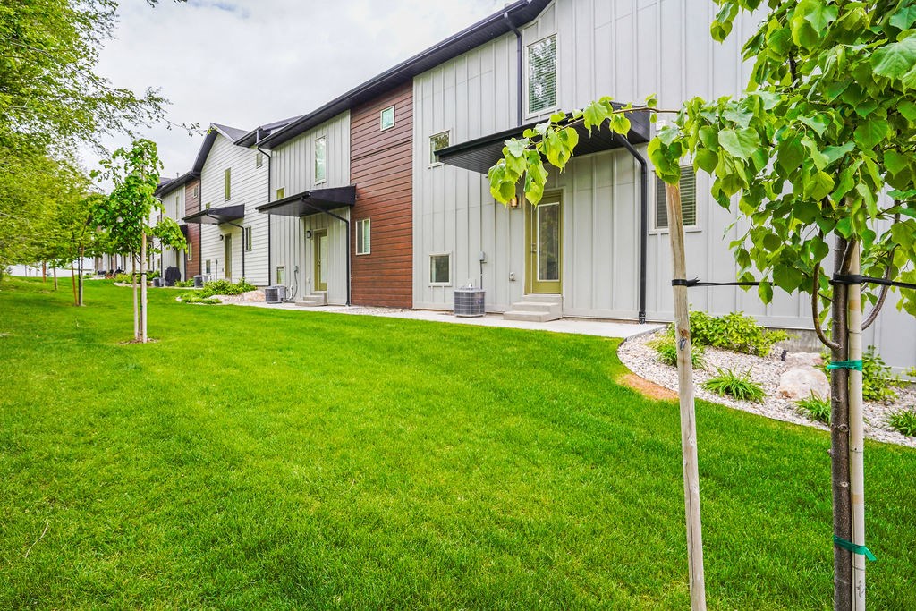 a row of houses with a yard and grass