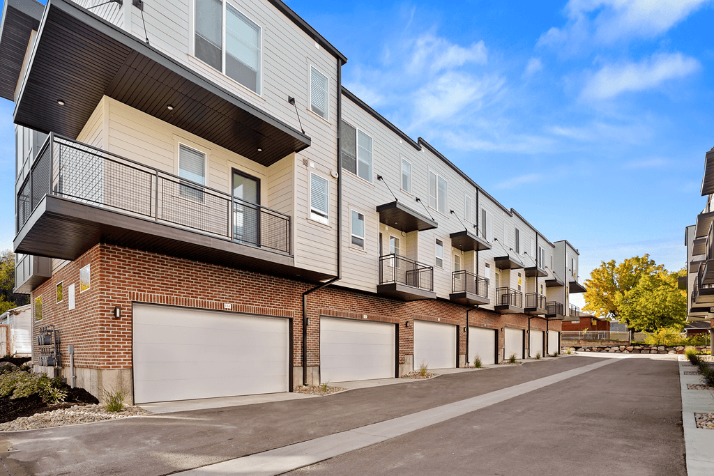 the exterior of an apartment building with white doors