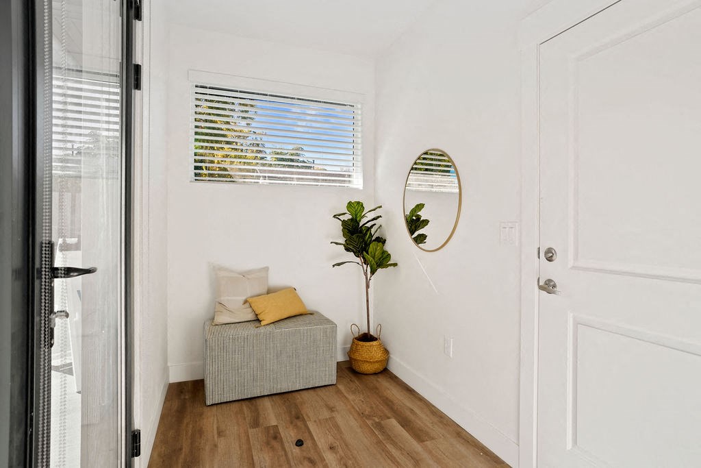 a living room with a couch and a mirror on the wall