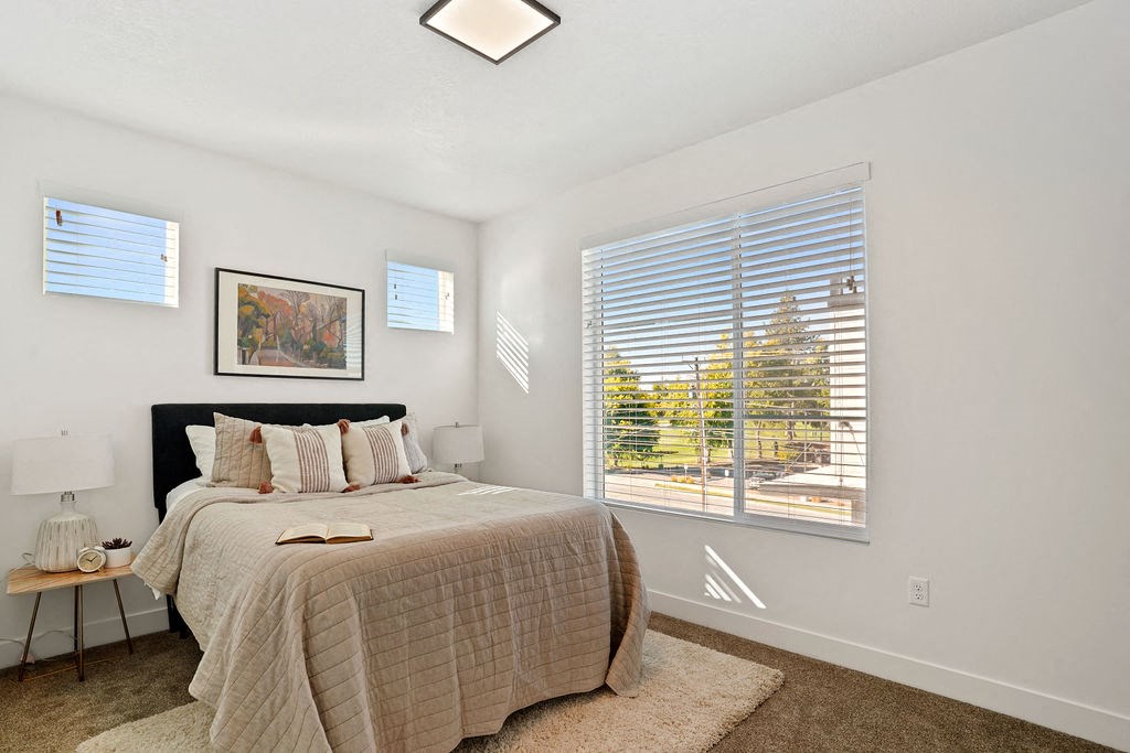 Decorated Bedroom with natural lights at Greens by Lotus Townhomes, Ogden, Utah