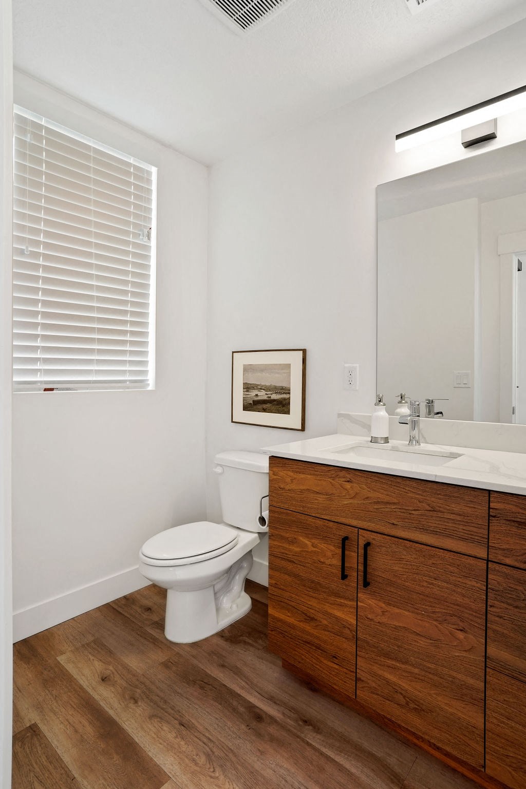 a bathroom with a toilet sink and a mirror
