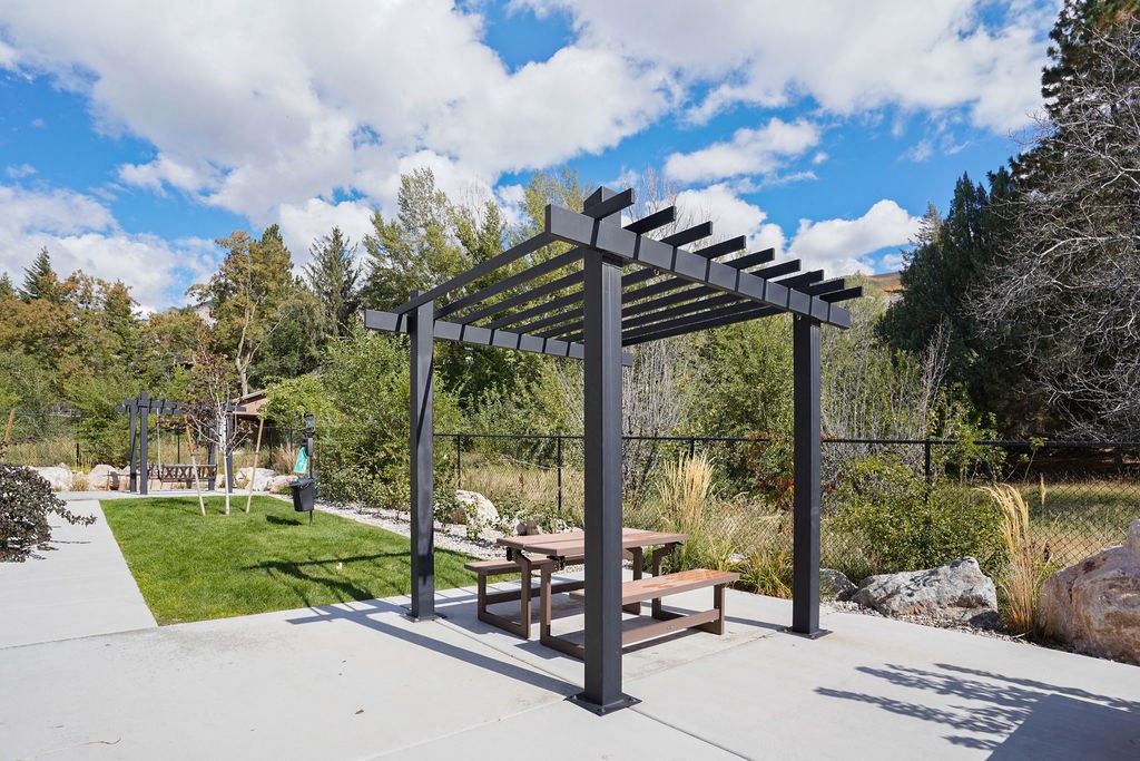 a picnic area with a picnic table and a pergola