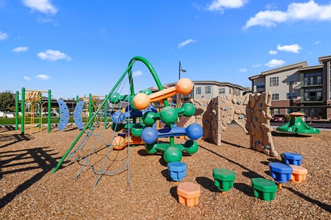 a playground with a swing set and other playground equipment