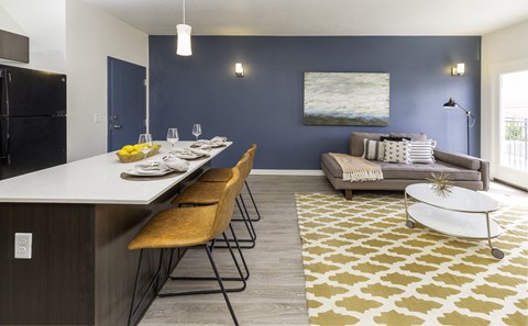A modern kitchen with a dining table and chairs.