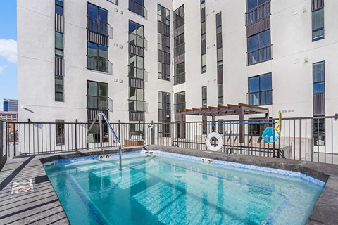 A swimming pool on a balcony of a building.