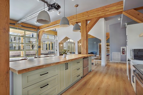 A kitchen with wooden cabinets and a large island.
