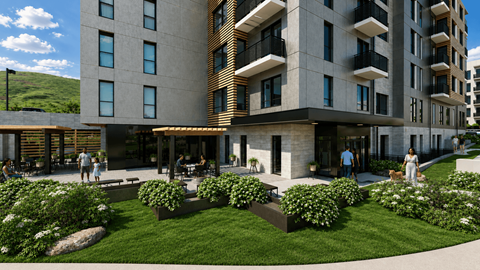 A modern building with a courtyard and people walking around.