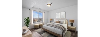 A bedroom with a large bed and a view of the outside through the window.