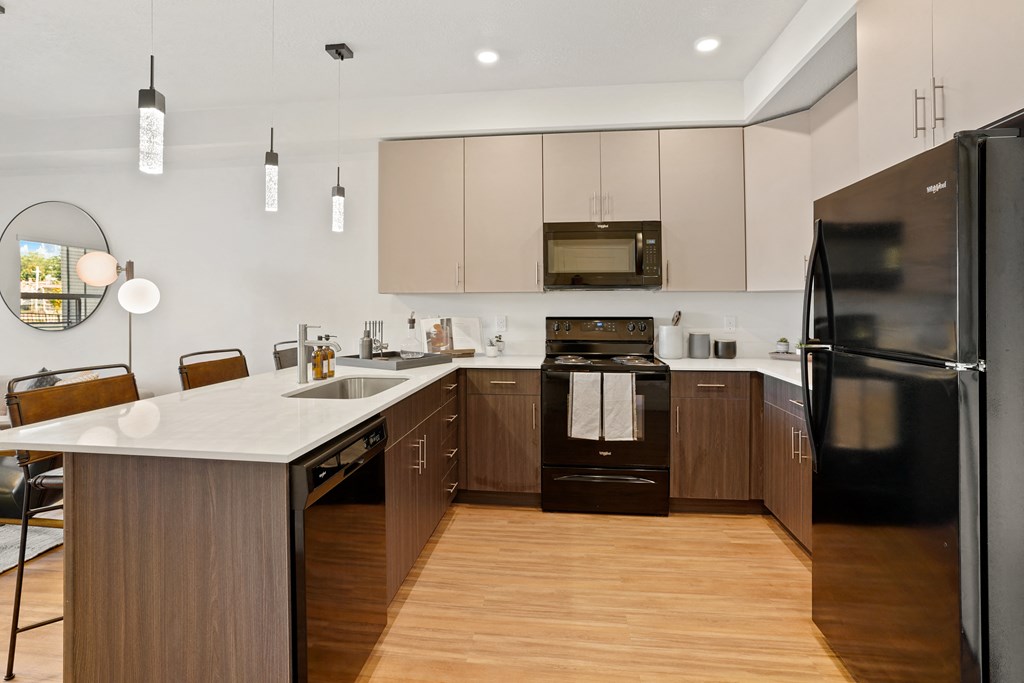 a large kitchen with wooden cabinets and a white counter top