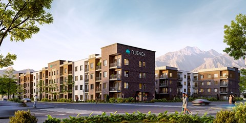 A modern apartment complex named Fluence is surrounded by mountains.