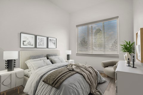 A bedroom with a large bed and a window with blinds.