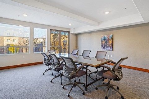 a conference room with a wooden table and chairs
