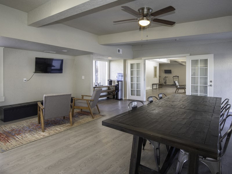 a living room with a large wooden table and chairs