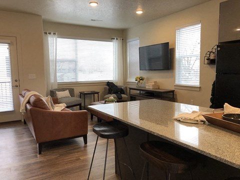 a kitchen and living room with a table and chairs