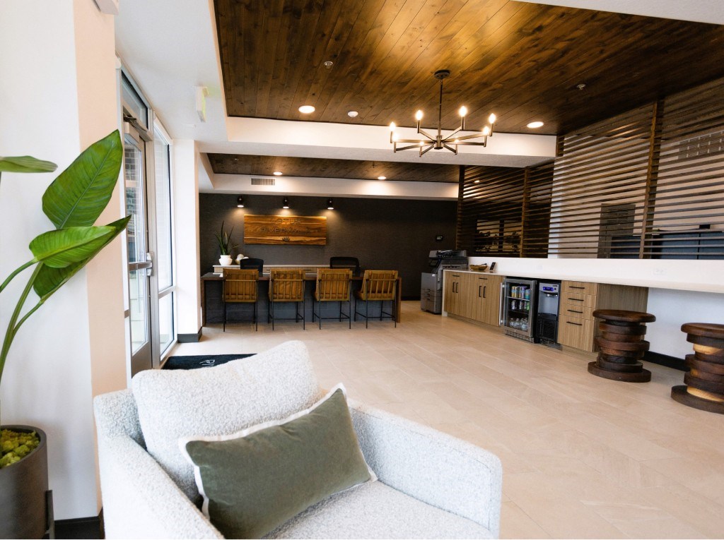 A living room with a white couch and a wooden ceiling.