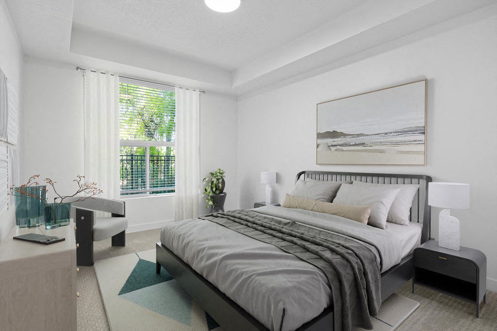 A bedroom with a large bed and a painting on the wall.