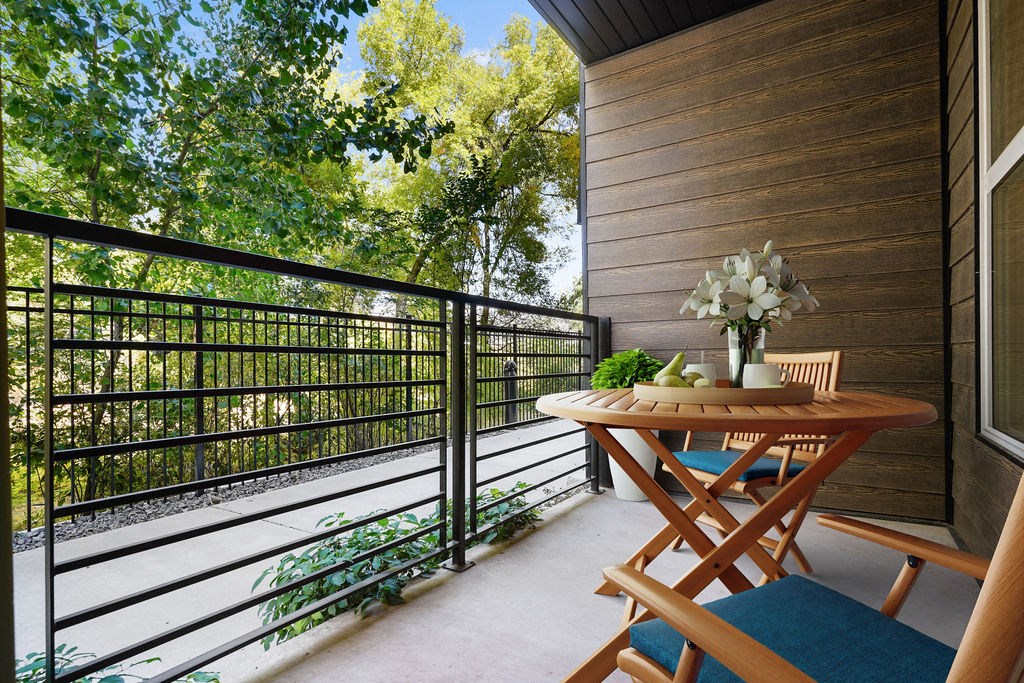 A wooden table with a vase of flowers on it.