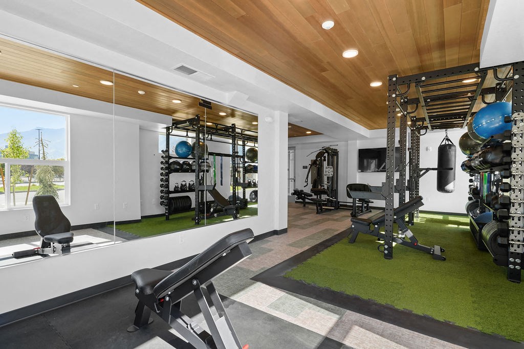 A gym with a bench and weights.