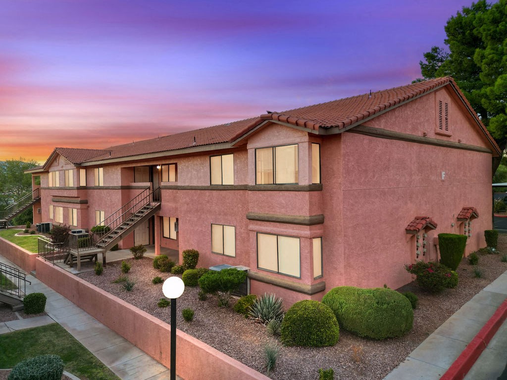 an aerial view of a brick house with a dusk sky