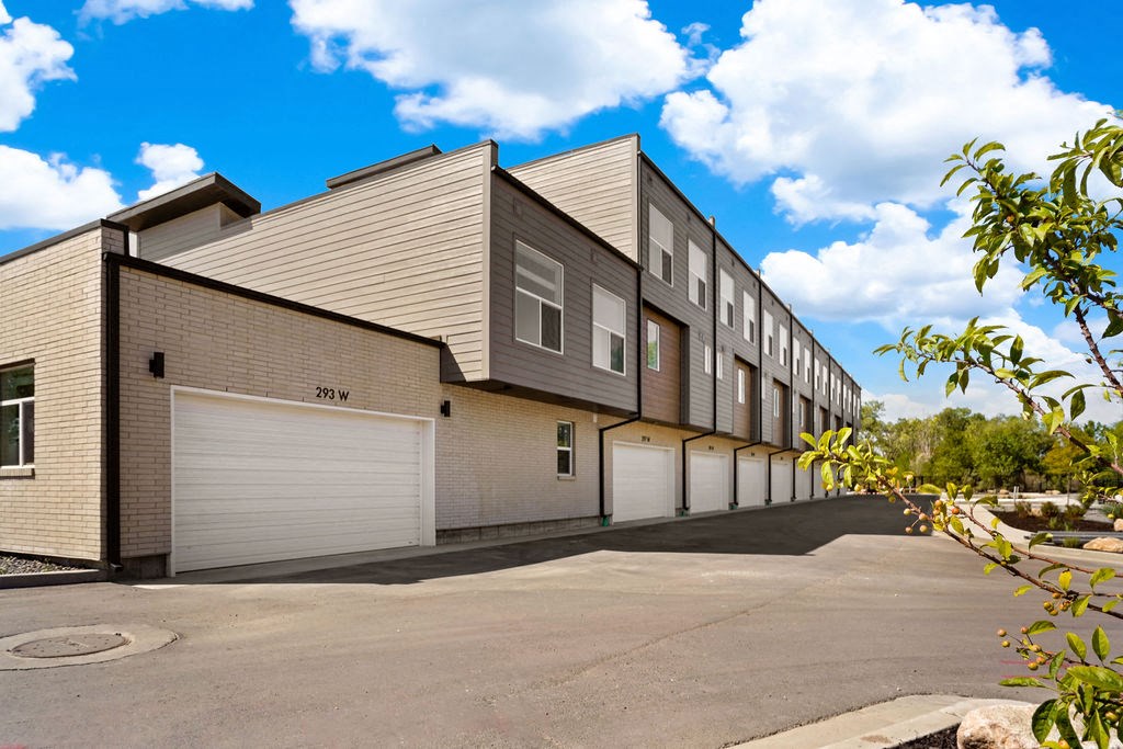 the exterior of a building with white garage doors