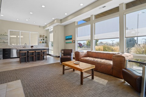 A living room with brown leather couches and a wooden coffee table.