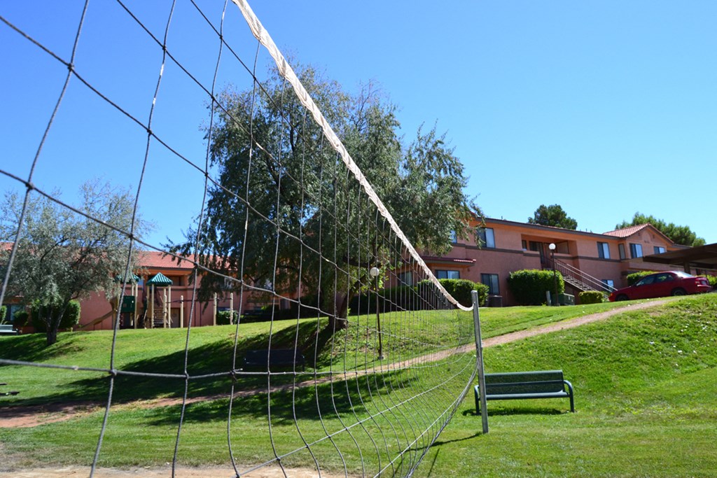 a swing set in a park in front of a building