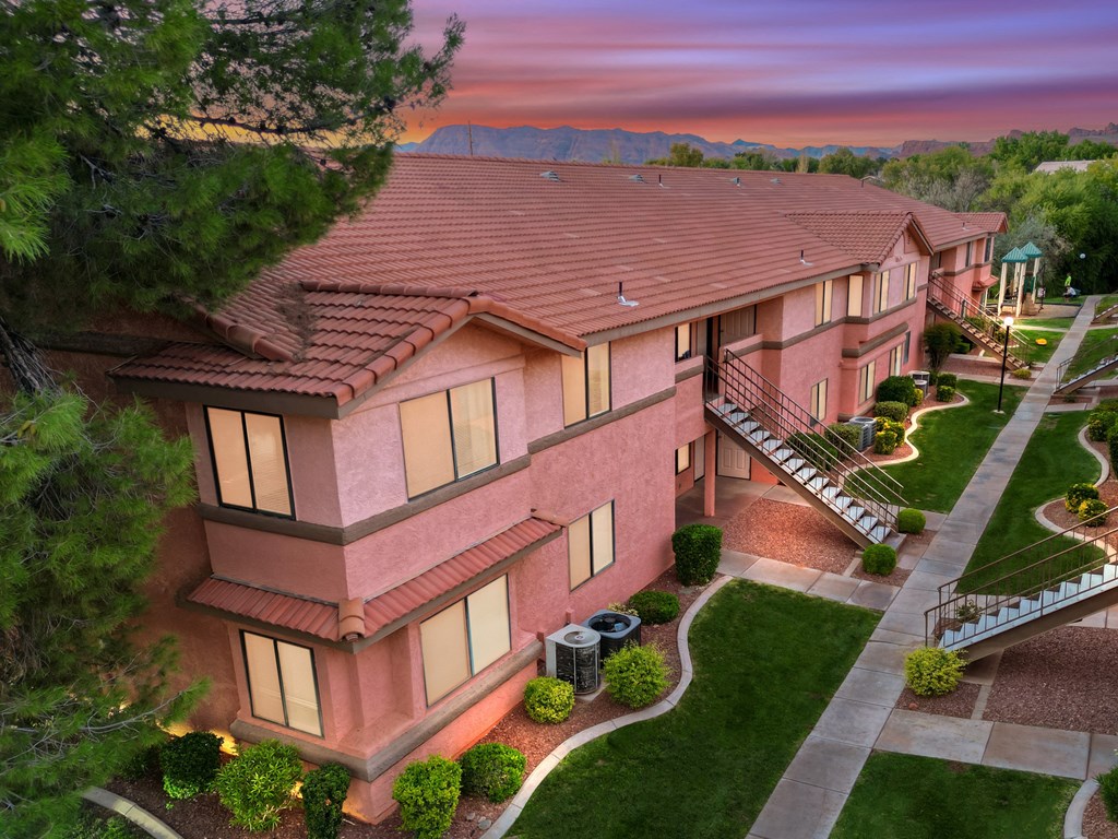 an aerial view of a house with a sunset behind it
