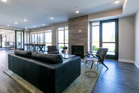 a large living room with a leather couch and a fireplace