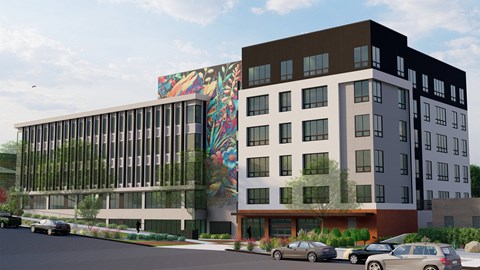 A modern building with a mural on the side.