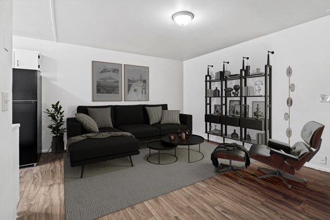 a living room with a black couch and a coffee table
