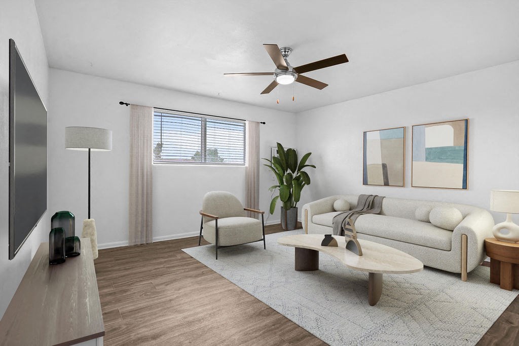 a living room with a couch and a ceiling fan