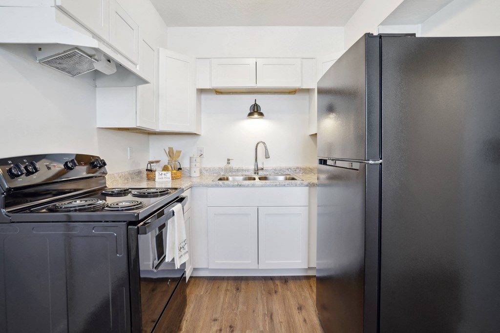 a kitchen with stainless steel appliances and white cabinets