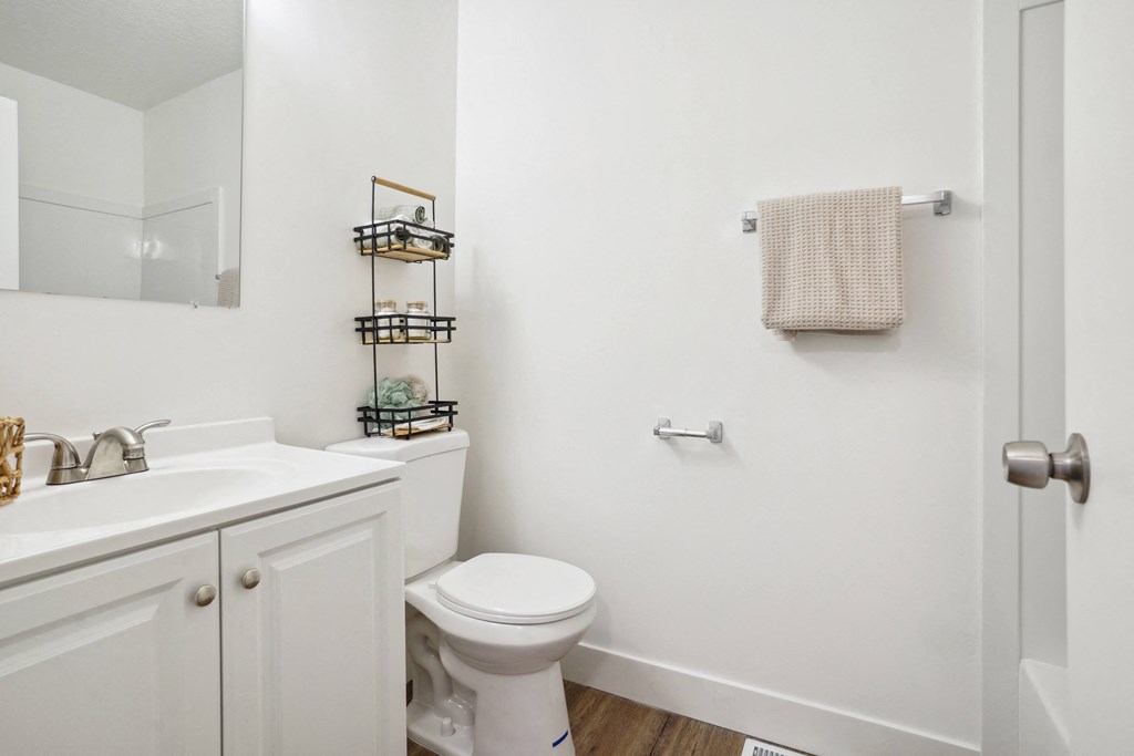 a bathroom with a sink toilet and a mirror