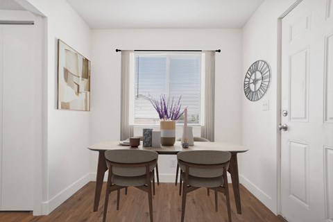 a dining room with a table and chairs and a window